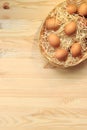 Brown chicken eggs in a basket on a wooden table Royalty Free Stock Photo