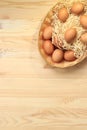 Brown chicken eggs in a basket on a wooden table Royalty Free Stock Photo