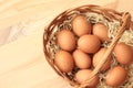 Brown chicken eggs in a basket on a wooden table Royalty Free Stock Photo