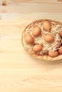 Brown chicken eggs in a basket on a wooden table Royalty Free Stock Photo