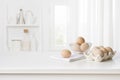 Brown chicken eggs in carton box on kitchen table interior Royalty Free Stock Photo