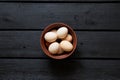 Brown chicken eggs in a clay bowl on a wooden table Royalty Free Stock Photo
