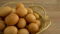 Brown chicken eggs in gray basket package box on wooden table Royalty Free Stock Photo