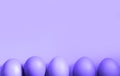Purple chicken eggs on a orange background. Very peri tinting. Easter spring backgrounds. Copy space, frame with a lower border