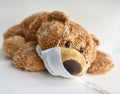 Plush toy bear in a medical mask