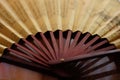 Brown chinese style fan on the table, close up, side view Royalty Free Stock Photo