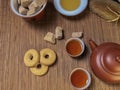 Brown chinese tea set of a teapots and two cups, cookies and brown sugar on bamboo table mat . Royalty Free Stock Photo