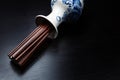 Brown chinese wood chopsticks in traditional russian slyle vase