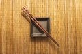 Brown Chopsticks Placed With Serving Dish On Place Mat