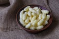 A brown clay bowl full of puffcorn Royalty Free Stock Photo