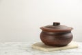 Brown clay pot on white marble table. Space for text Royalty Free Stock Photo