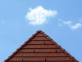 Brown clay tile sloped pitched roof. blue sky and white clouds. Royalty Free Stock Photo