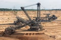 Brown coal open pit landscape with digging excavator in Germany Royalty Free Stock Photo