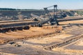 Brown coal open pit landscape with digging excavator in Germany Royalty Free Stock Photo