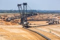 Brown coal open pit landscape with digging excavator in Germany Royalty Free Stock Photo