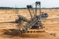 Brown coal open pit landscape with digging excavator in Germany Royalty Free Stock Photo