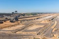 Brown coal open pit landscape with digging excavator in Germany Royalty Free Stock Photo