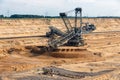 Brown coal open pit landscape with digging excavator in Germany Royalty Free Stock Photo