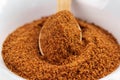 Brown coconut sugar granules with a full teaspoon Royalty Free Stock Photo