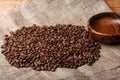 Brown coffee beans on the bag with empty wooden dish Royalty Free Stock Photo