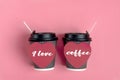 Brown coffee cups, red heart-shaped sticker on pink background.