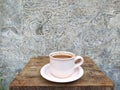 Brown coffee in white cup on ancient wooden table