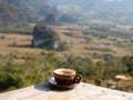 Cofffee Cup on The Wooden Table behind The Mountain Royalty Free Stock Photo