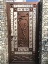 Brown color galvanised enamel painted prefabricated single leaf wicked gate for an villa backside and flower designed in the gate Royalty Free Stock Photo