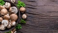 Brown colored common mushrooms in wooden bowl on wooden table with herbs. Top view