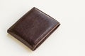 Brown colored leather wallet closed on white surface Royalty Free Stock Photo