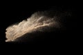 Brown colored sand splash.Dry river sand explosion isolated on black background. Abstract sand cloud