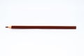 Brown colored sharped wood pencil crayon  on a white background Royalty Free Stock Photo