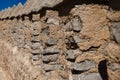 Brown columns made of stones in one long row Royalty Free Stock Photo