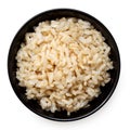 Brown cooked rice in a black ceramic bowl isolated on white from above Royalty Free Stock Photo