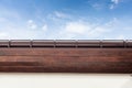 Brown copper gutter under a cloudy blue sky. Royalty Free Stock Photo