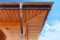 Brown copper gutter under a cloudy blue sky. Royalty Free Stock Photo