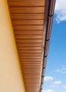 Brown copper gutter under a cloudy blue sky. Royalty Free Stock Photo