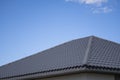 Brown corrugated metal profile roof installed on a modern house. The roof of corrugated sheet. Roofing of metal profile