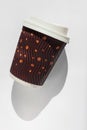 Coffee to go on a white background isolated. Brown kraft paper cup with black lid, lifestyle concept