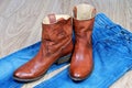 Brown cowboy boots on blue jeans Royalty Free Stock Photo