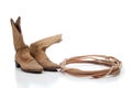 Brown cowboy boots and a lariat on white Royalty Free Stock Photo