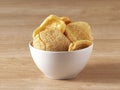 Brown crackers served in a white bowl