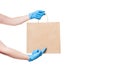 Brown craft paper eco friendly package holds hand of deliveryman.