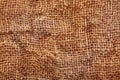 Brown crumpled burlap texture background. Macro of hessian cloth