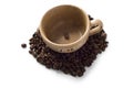 Brown cup with coffee beans around it Royalty Free Stock Photo