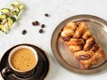 A brown cup with espresso next to maple pecans with nuts and syrup. Fresh coffee beans, ivy branch. Located on a gray background. Royalty Free Stock Photo