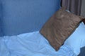 Brown cushion and blue sheet on a lounge chair