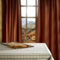 A brown cutting board on table with blurred mountains and blue cloudy sky background behind the window. Royalty Free Stock Photo