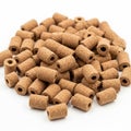Brown cylindrical objects with a central hole resembling granular pellets Royalty Free Stock Photo