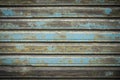 Brown, dark, green and grey old wooden texture background. Scratched weathered wooden wall with peeled off blue paint close up Royalty Free Stock Photo